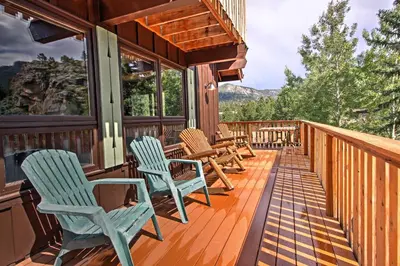 a deck with chairs and tables on a house at Peaceful Pines Estes Park Home Longs Peak View in Estes Park