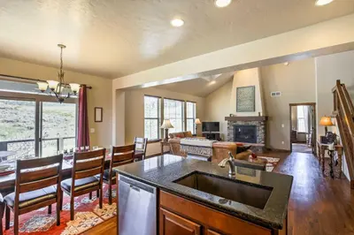 a kitchen and living room with a sink and a fireplace at Patio, Fire Pit, and Ski Mountain View Granby Home in Granby