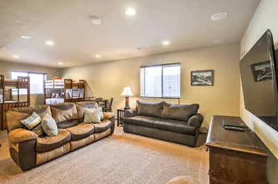 a living room with two couches and a flat screen tv at Patio, Fire Pit, and Ski Mountain View Granby Home in Granby
