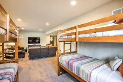 a bedroom with two bunk beds and a living room at Patio, Fire Pit, and Ski Mountain View Granby Home in Granby