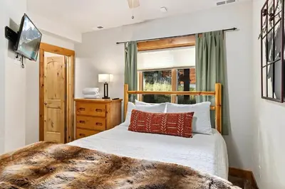 a bedroom with a bed and a window at Updated and Spacious Lodge in Heart of Estes Park! in Estes Park