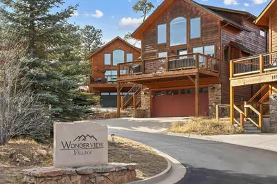 a house with a sign in front of it at Updated and Spacious Lodge in Heart of Estes Park! in Estes Park