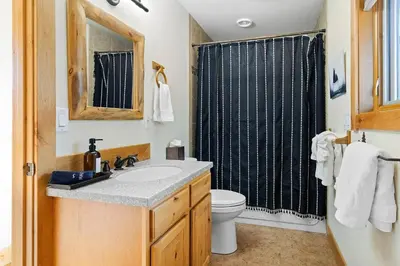 a bathroom with a sink and a toilet and a shower at Updated and Spacious Lodge in Heart of Estes Park! in Estes Park