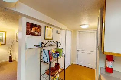 a hallway with a room with a door and a shelf at Elati Guesthouse Walkable Home in Arts District in Denver