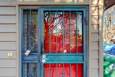 a blue door with glass windows on a house at Elati Guesthouse Walkable Home in Arts District in Denver