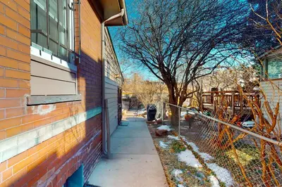a sidewalk next to a building with a tree at Elati Guesthouse Walkable Home in Arts District in Denver