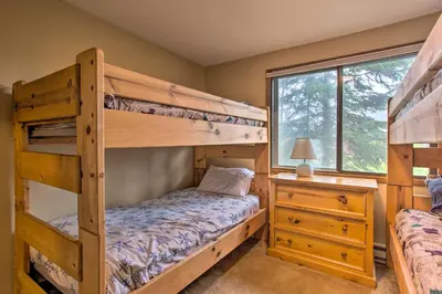 a bedroom with two bunk beds and a window at Sprawling Fraser Cabin with Private Hot Tub and Deck! in Fraser