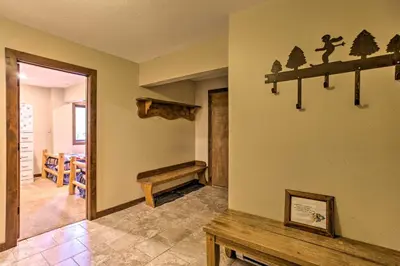 a hallway with a living room and a dining room at Sprawling Fraser Cabin with Private Hot Tub and Deck! in Fraser