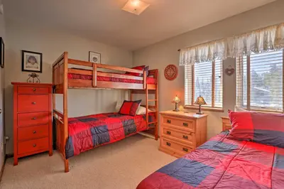 a bedroom with two bunk beds and a desk at Pet-Friendly Fraser Condo with Community Hot Tub in Fraser