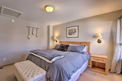 a bedroom with a bed and a bench in it at Pet-Friendly Fraser Condo with Community Hot Tub in Fraser