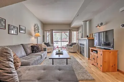 a living room with a couch and a flat screen tv at Pet-Friendly Fraser Condo with Community Hot Tub in Fraser