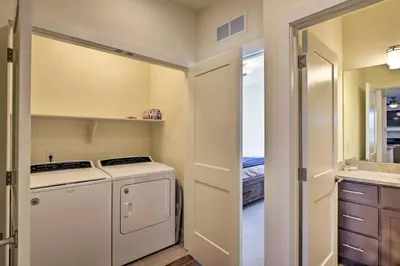 a laundry room with a white washer and dryer at Mountain Escape with Hot Tub Less Than 5 Mi to Winter Park! in Fraser