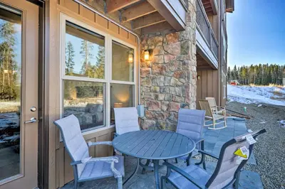 a patio with a table and chairs on a building at Mountain Escape with Hot Tub Less Than 5 Mi to Winter Park! in Fraser