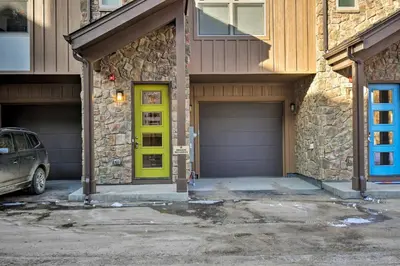 a garage with a yellow door in front of a house at Mountain Escape with Hot Tub Less Than 5 Mi to Winter Park! in Fraser