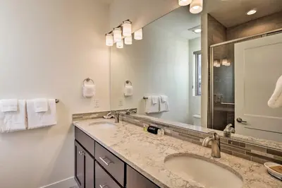 a bathroom with two sinks and a large mirror at Mountain Escape with Hot Tub Less Than 5 Mi to Winter Park! in Fraser