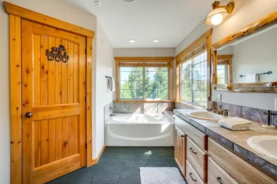 a bathroom with a tub and a sink and a bath tub at 2 Mi to Frisco Slopes Cozy Retreat with Mtn Views! in Frisco