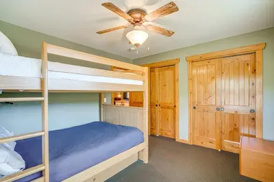 a bedroom with two bunk beds and a ceiling fan at 2 Mi to Frisco Slopes Cozy Retreat with Mtn Views! in Frisco