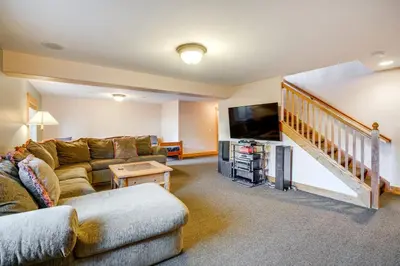 a living room with a couch and a flat screen tv at 2 Mi to Frisco Slopes Cozy Retreat with Mtn Views! in Frisco