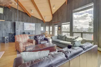 a living room with a couch and a table at Panoramic Mountain-View Retreat with Hot Tub and Deck! in Tabernash