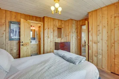 a bedroom with wooden walls and a bed in it at Panoramic Mountain-View Retreat with Hot Tub and Deck! in Tabernash