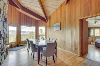a dining room with a table and chairs at Panoramic Mountain-View Retreat with Hot Tub and Deck! in Tabernash