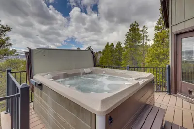 a hot tub on the deck of a house at Panoramic Mountain-View Retreat with Hot Tub and Deck! in Tabernash