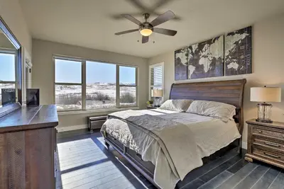 a bedroom with a bed and a ceiling fan at 3 Mi to Granby Ranch Expansive Granby Retreat! in Granby
