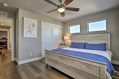 a bedroom with a bed with a ceiling fan at 3 Mi to Granby Ranch Expansive Granby Retreat! in Granby