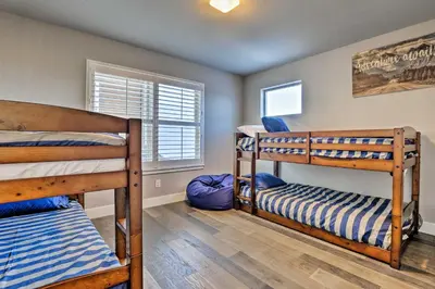 a bedroom with two bunk beds and a window at 3 Mi to Granby Ranch Expansive Granby Retreat! in Granby