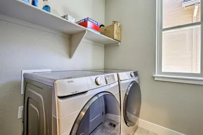 a washing machine in a laundry room with a window at 3 Mi to Granby Ranch Expansive Granby Retreat! in Granby