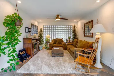 a living room with a couch and a fireplace at Modern Creekside Home 9 Mi to Downtown Denver in Lakewood