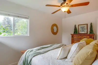 a bedroom with a ceiling fan and a bed at Modern Creekside Home 9 Mi to Downtown Denver in Lakewood