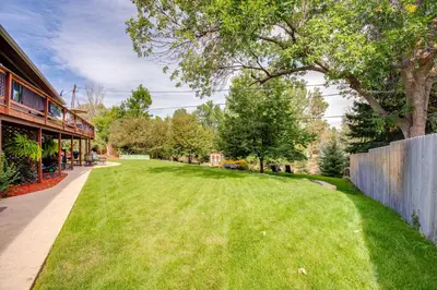 a large grassy yard next to a building at Modern Creekside Home 9 Mi to Downtown Denver in Lakewood