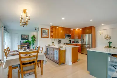 a kitchen and dining room with a table and chairs at Modern Creekside Home 9 Mi to Downtown Denver in Lakewood