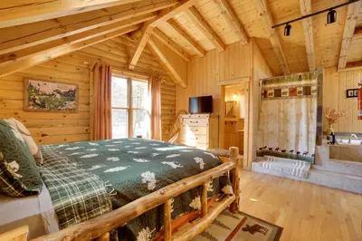 a bedroom with a bed in a log cabin at Picturesque Log Cabin in Estes Park 9 Mi to RMNP in Estes Park