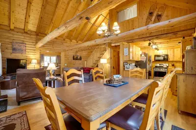 a dining room and kitchen in a log cabin at Picturesque Log Cabin in Estes Park 9 Mi to RMNP in Estes Park