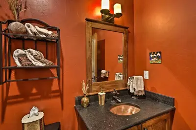 a bathroom with a sink and a mirror at 6 Mi to Slopes Breck Home with Hot Tub and Game Room in Breckenridge