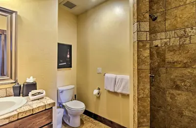 a bathroom with a toilet and a sink and a shower at 6 Mi to Slopes Breck Home with Hot Tub and Game Room in Breckenridge
