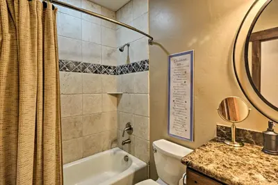 a bathroom with a tub and a toilet and a sink at 6 Mi to Slopes Breck Home with Hot Tub and Game Room in Breckenridge