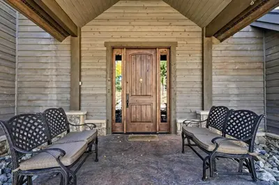 a porch with two benches and a wooden door at 6 Mi to Slopes Breck Home with Hot Tub and Game Room in Breckenridge