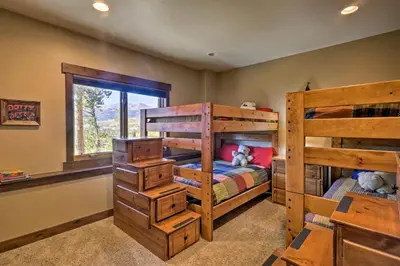 a bedroom with two bunk beds and a window at 6 Mi to Slopes Breck Home with Hot Tub and Game Room in Breckenridge