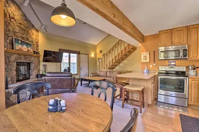 a kitchen and living room with a table and chairs at Townhome with Club Access on Shuttle Stop in Fraser