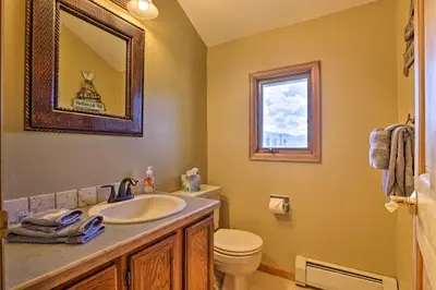 a bathroom with a sink and a toilet and a mirror at Townhome with Club Access on Shuttle Stop in Fraser