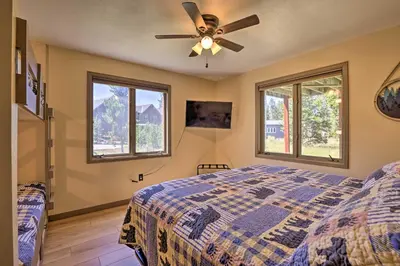 a bedroom with a ceiling fan and two windows at Townhome with Club Access on Shuttle Stop in Fraser