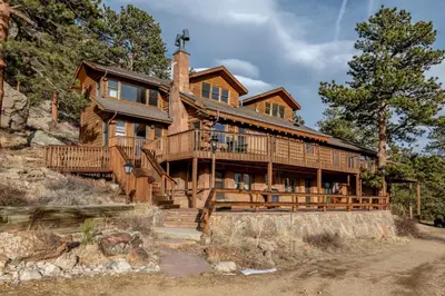 a large wooden house on a mountain at Bishop's Retreat in Estes Park