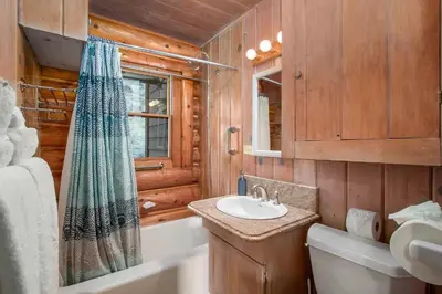 a bathroom with a sink and a toilet and a tub at Bishop's Retreat in Estes Park