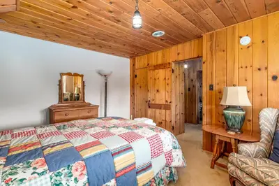 a bedroom with a bed and a chair at Bishop's Retreat in Estes Park