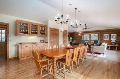 a kitchen and dining room with a wooden table and chairs at Bishop's Retreat in Estes Park