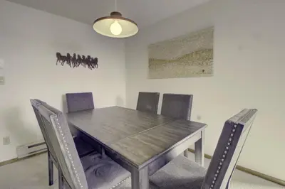 a dining room with a wooden table and chairs at 432 Marina Place condo in Dillon