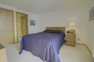 a bedroom with a purple bed and a night stand at 432 Marina Place condo in Dillon